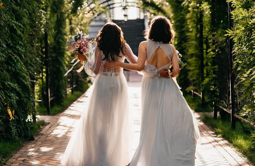 Two,Happy,Lesbian,Lgbt,Brides,Wearing,Boho,Dresses,Walking,Through